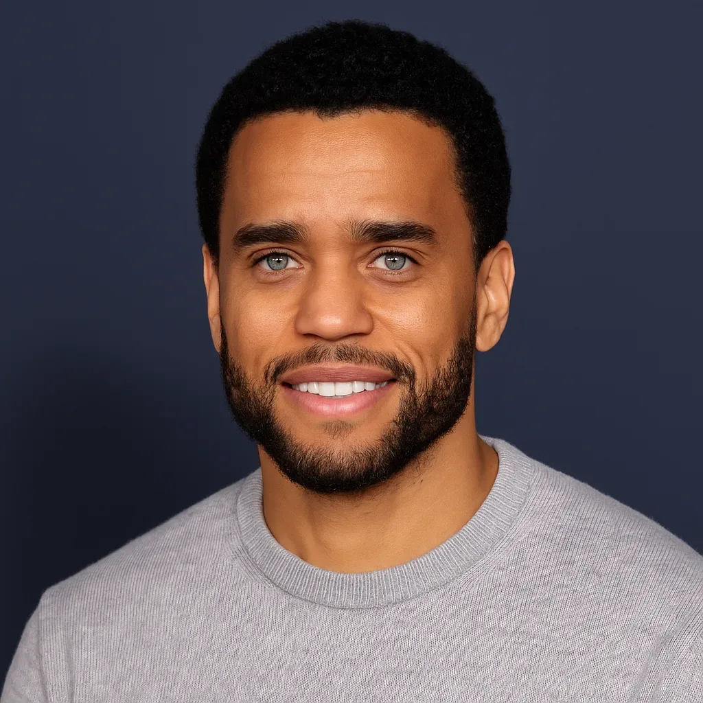 Smiling male gig worker from Kelowna, BC with confident expression, wearing a grey sweater in professional portrait after being approved for a vehicle loan using DoorDash income